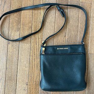 Michael Kors Black leather Crossbody bag with gold detailing.